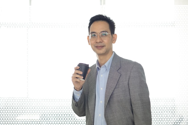 Portrait Asian business man standing look at camera in modern office