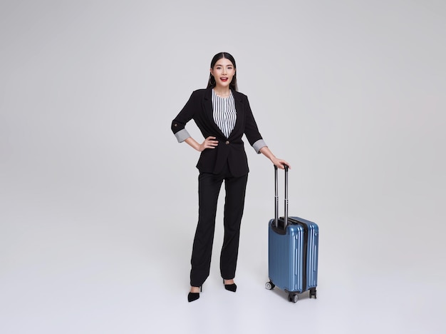 Portrait Asian business woman travel wearing a suit with suitcase isolated on white background