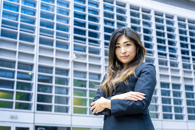 Portrait of a Asian business woman with crossed arms looking at the camera in a confident way woman month equality and women's rights concepts