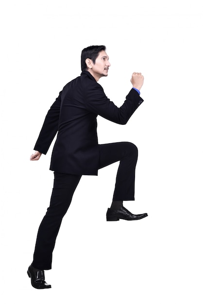 Portrait of asian businessman walking up stairs