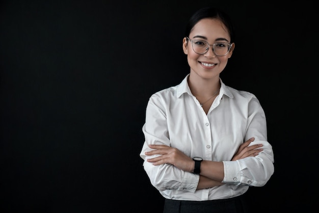 Portrait of asian businesswoman in formal wear standing with her arms crossed