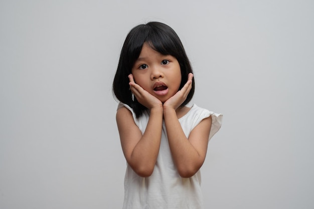 Portrait of Asian child 5 year old and to collect hair and Place her hands on her chin