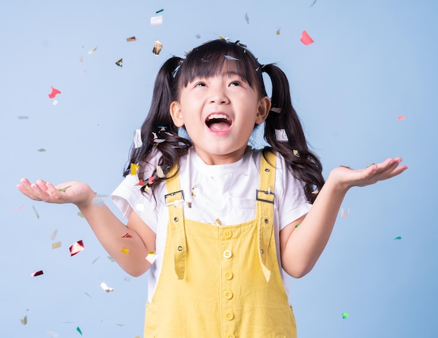 Portrait of Asian child posing on blue background