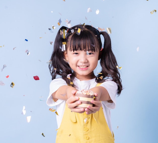 Portrait of Asian child posing on blue background