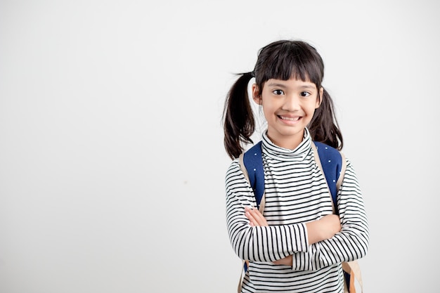 Portrait of Asian child in school uniform with school bag on white background