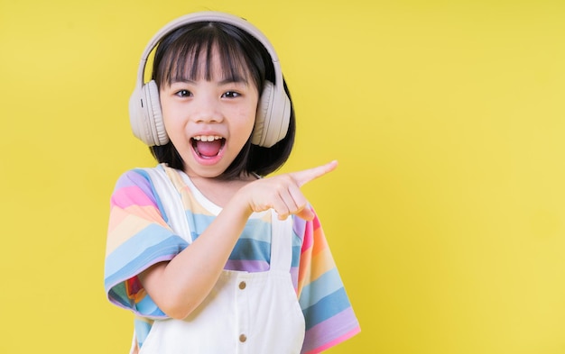 Portrait of Asian child on yellow background