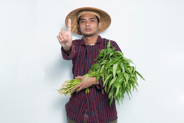 Portrait of asian farmer with open hand doing stop sign with serious expression defense gesture