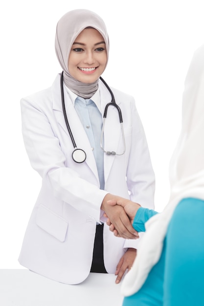 Portrait of asian female doctor shake hands with her patient