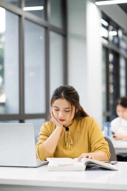 Portrait of Asian female student studying at university library