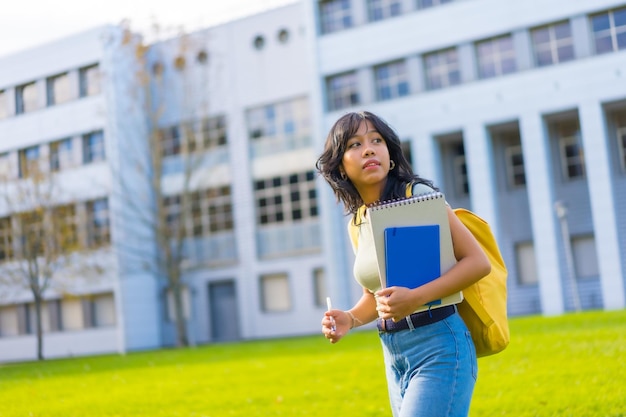 Photo portrait of asian girl on campus student concept with blocks in hand university