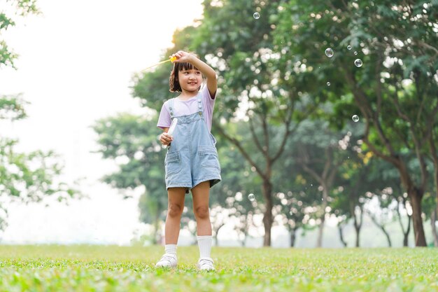 Portrait of asian girl playing blowing bubbles