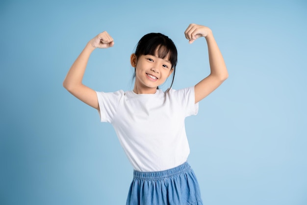 Portrait of Asian girl posing on blue background