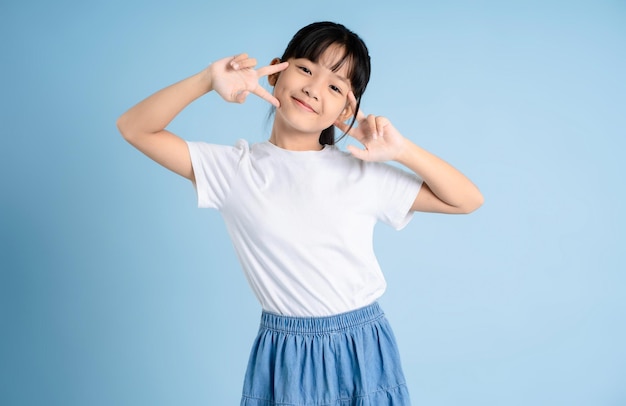 Portrait of Asian girl posing on blue background