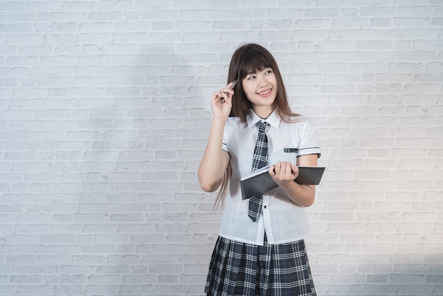 Portrait of asian girl on white wall background