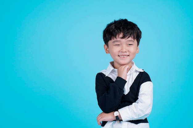 Portrait of Asian handsome little kid boy isolated on blue background