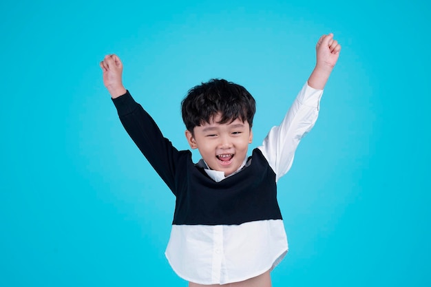 Portrait of Asian handsome little kid boy isolated on blue background