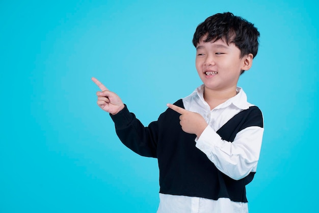 Portrait of Asian handsome little kid boy isolated on blue background