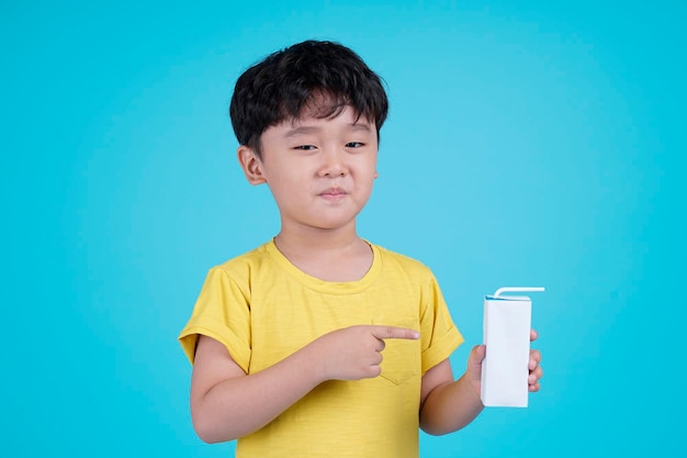 Portrait of Asian handsome little kid boy isolated on blue background