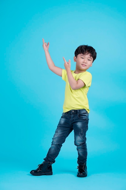 Portrait of Asian handsome little kid boy isolated on blue background