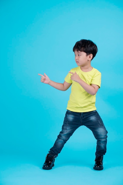 Portrait of Asian handsome little kid boy isolated on blue background