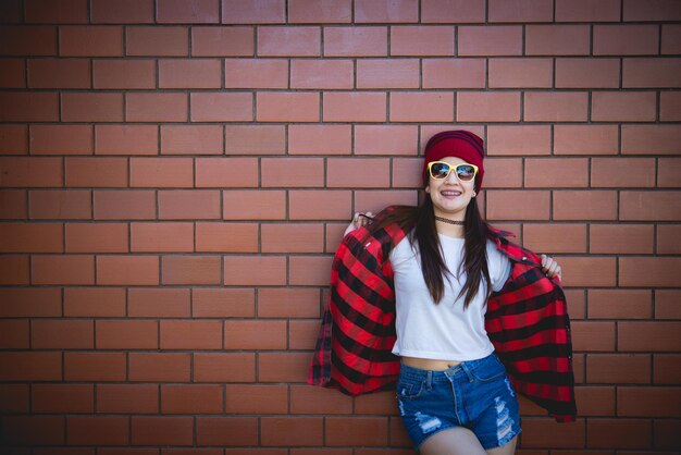 Portrait asian hipster girl on brick wall backgroundLifestyle of thailand people