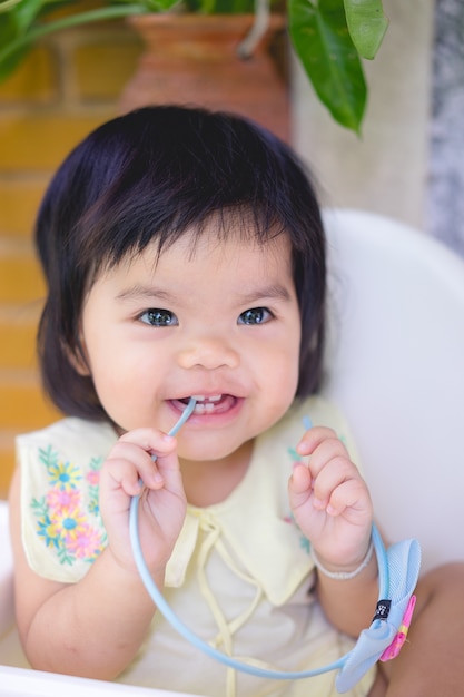 Portrait of Asian little girl smiling. Childish smile is a source of positive emotions.