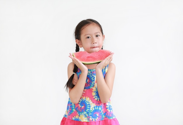 Portrait asian little kid girl eating watermelon isolated on white background