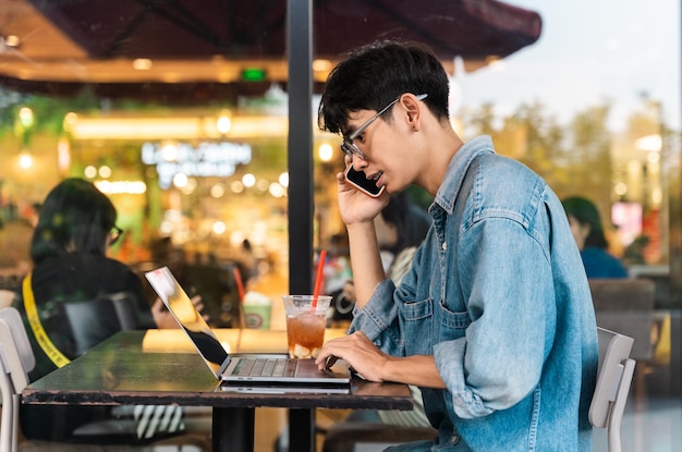 Portrait of Asian male student sitting at a coffee shop