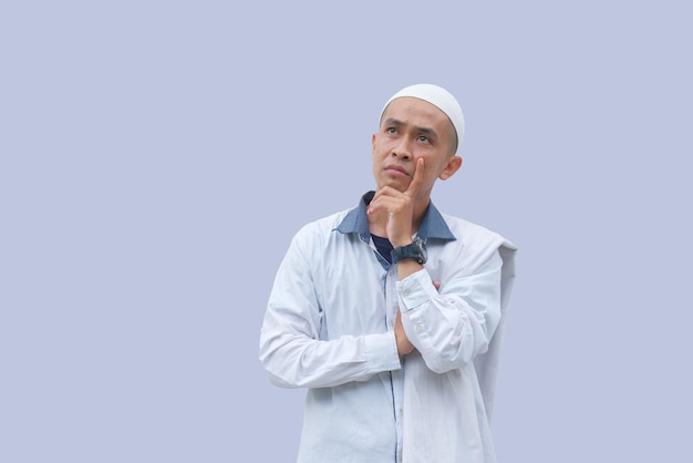 Portrait of asian man daydreaming isolated in white