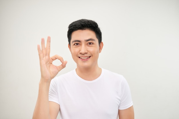 Portrait of an asian man doing the okay gesture