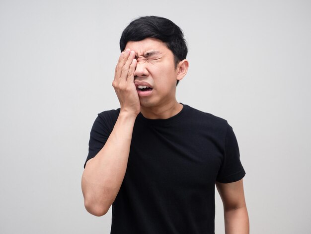 Portrait asian man feels hurt his eye isolated