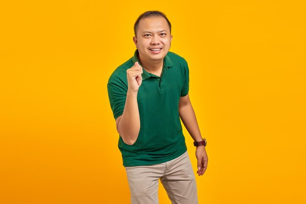 Portrait of asian man showing hand gesture folding fingers in front of camera with funny expression