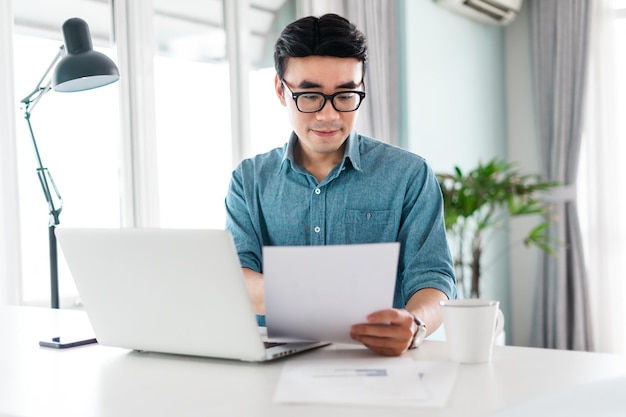 Portrait of asian man sitting working from home