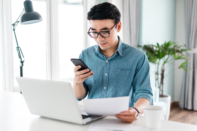 Portrait of asian man sitting working from home