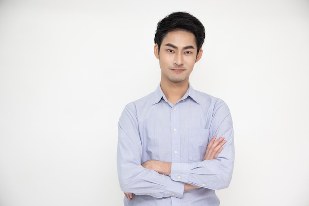 Portrait of Asian man with arms crossed and smile isolated over white background