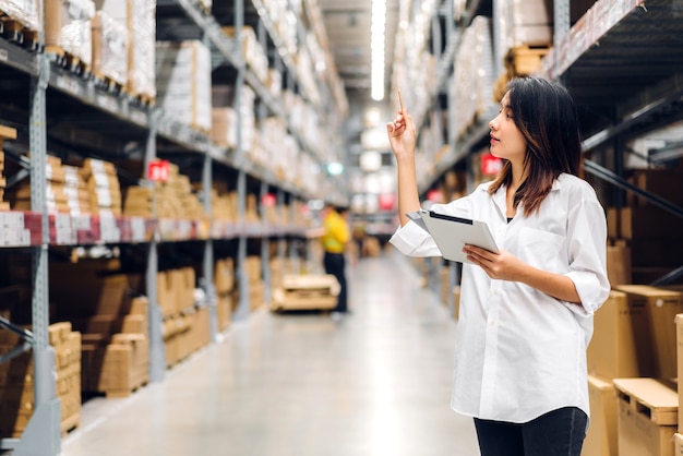 Portrait of asian manager worker woman standing and order details on tablet