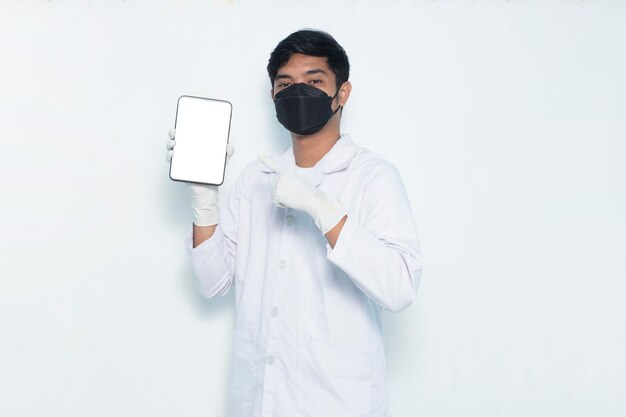 Portrait of asian medical doctor wear masks demonstrating mobile cell phone isolated on white