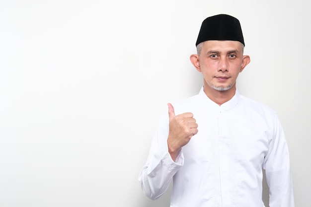 Portrait of Asian Moslem Man explain something with thumbs up