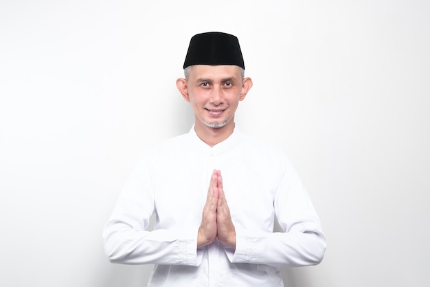 Portrait Asian Moslem Man with greetings and welcoming gestures ,smiling face