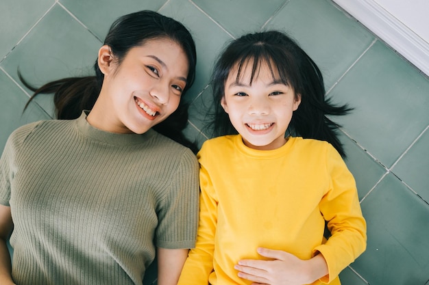 Portrait of Asian mother and daughter at home