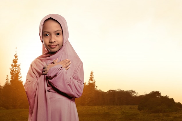 Portrait of asian muslim child wearing veil standing