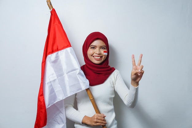 Portrait of Asian Muslim Women Celebrate Indonesian independence day holding Red and white flag