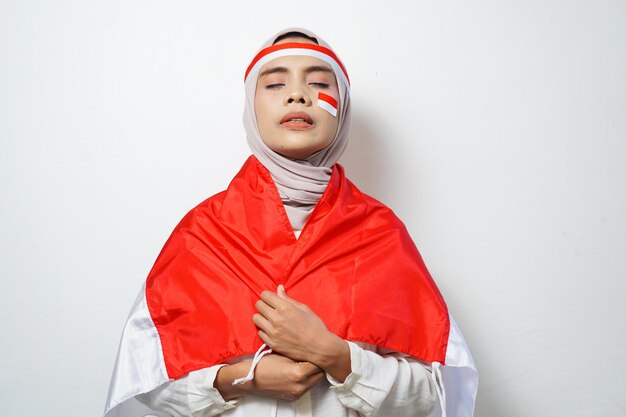 Portrait of asian muslim women celebrate indonesian independence day holding red and white flag