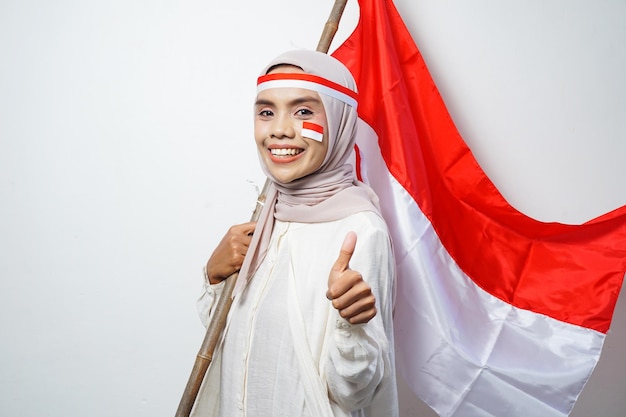 Portrait of Asian Muslim Women celebrate Indonesian independence day holding red and white flag