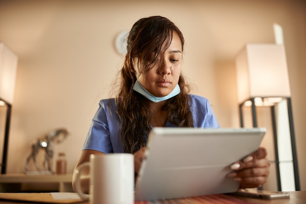 Portrait of Asian nurse at home