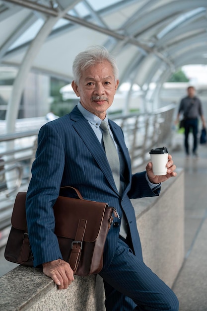 Portrait of Asian senior mature middle aged businessman in modern city