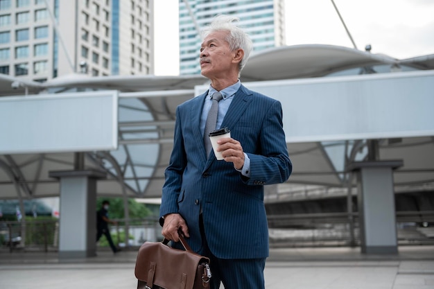 Portrait of Asian senior mature middle aged businessman in modern city