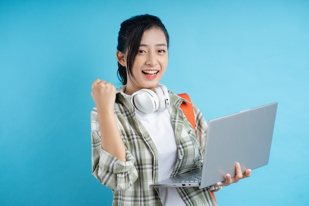 Portrait of Asian student on blue background