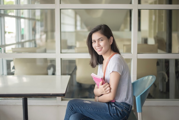 A portrait of an Asian university student on campus