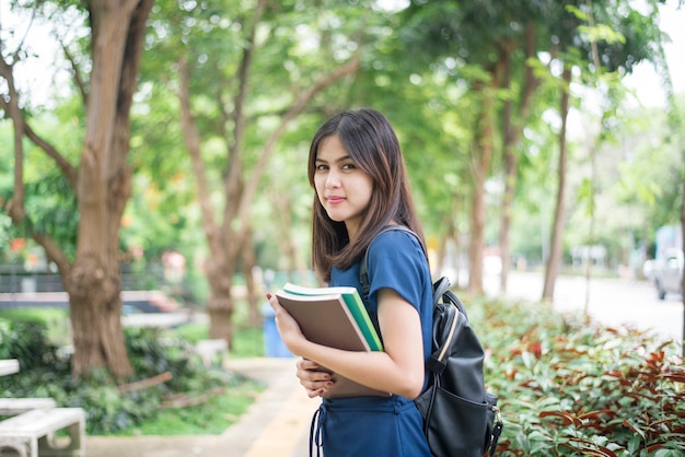 A portrait of an Asian university student on campus